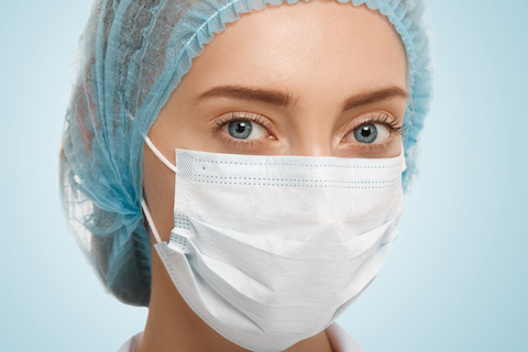 Woman wearing hairnet and facemask
