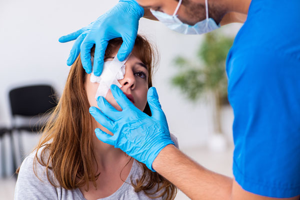 young woman with ocular injury being treated